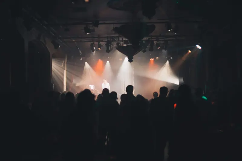 Beams of light crossing a corporate ballroom above a full floor