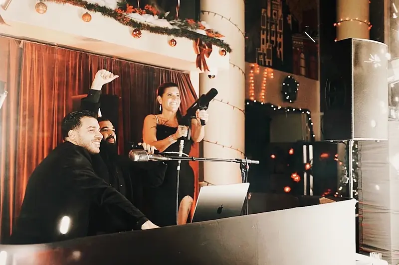 A company holiday party with the floor filled under warm lighting